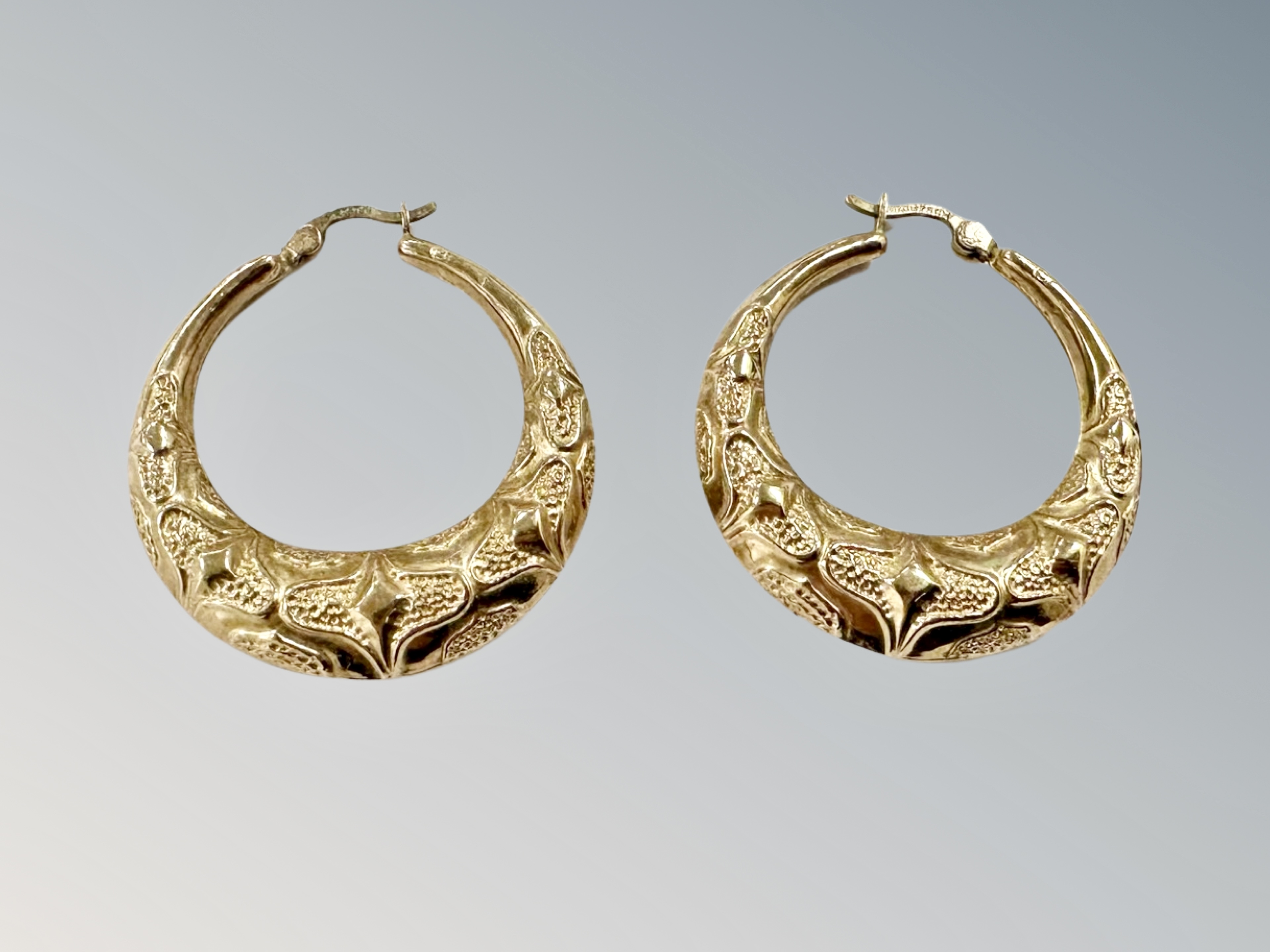 A pair of 9ct gold textured hoop earrings CONDITION REPORT: 3.