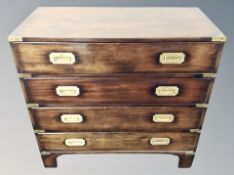 A campaign style chest of four drawers,