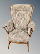 An Ercol elm and beech high backed armchair with cushions