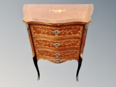 A French style Kingwood veneered shaped three drawer chest,