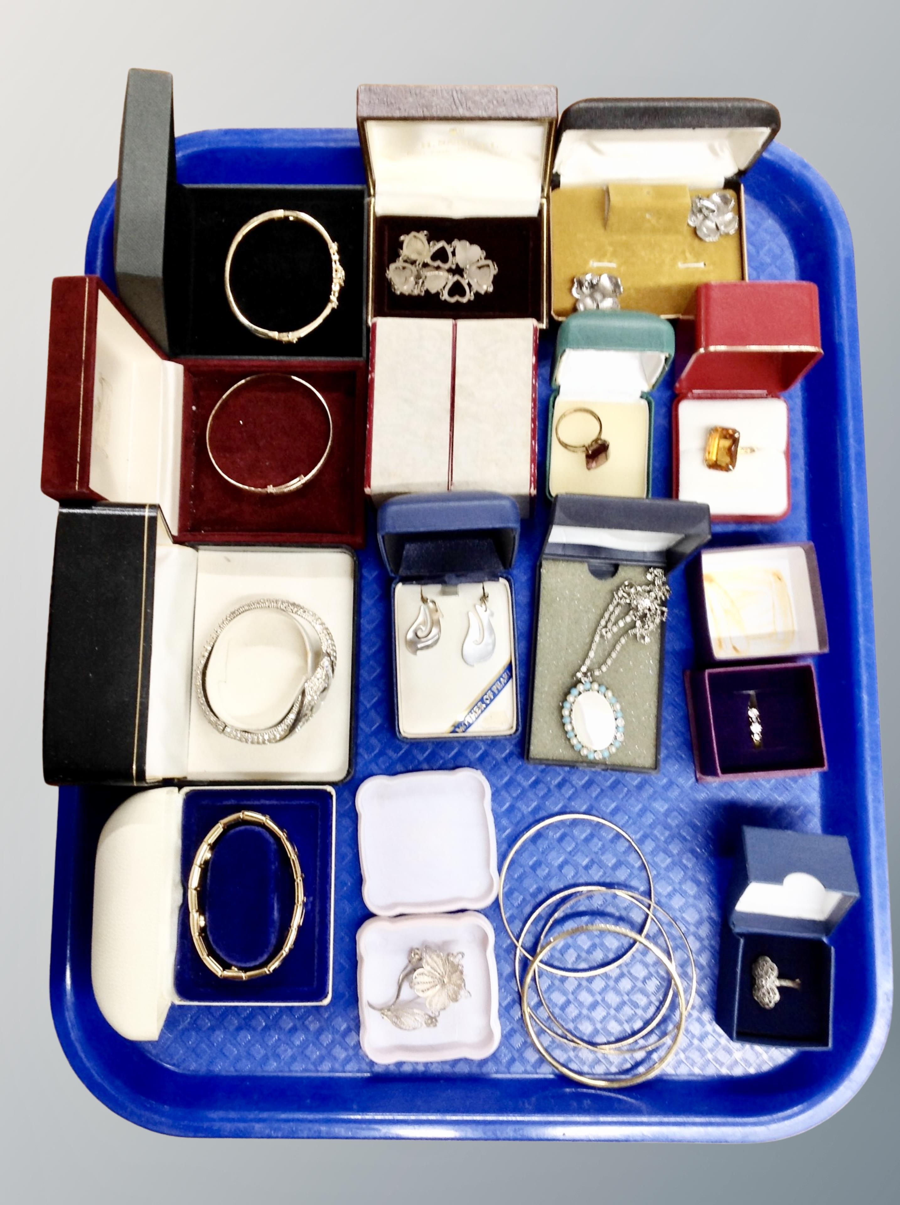 A tray of costume jewellery, rolled gold bangle, silver and dress rings, watch,