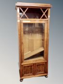 A Continental walnut glazed bookcase,