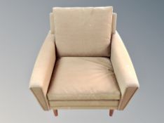 A Scandinavian armchair on teak legs in olive fabric