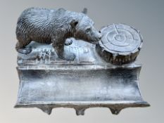 A Black Forest desk stand with inkwell and pen tray, surmounted by a bear, width 17cm.