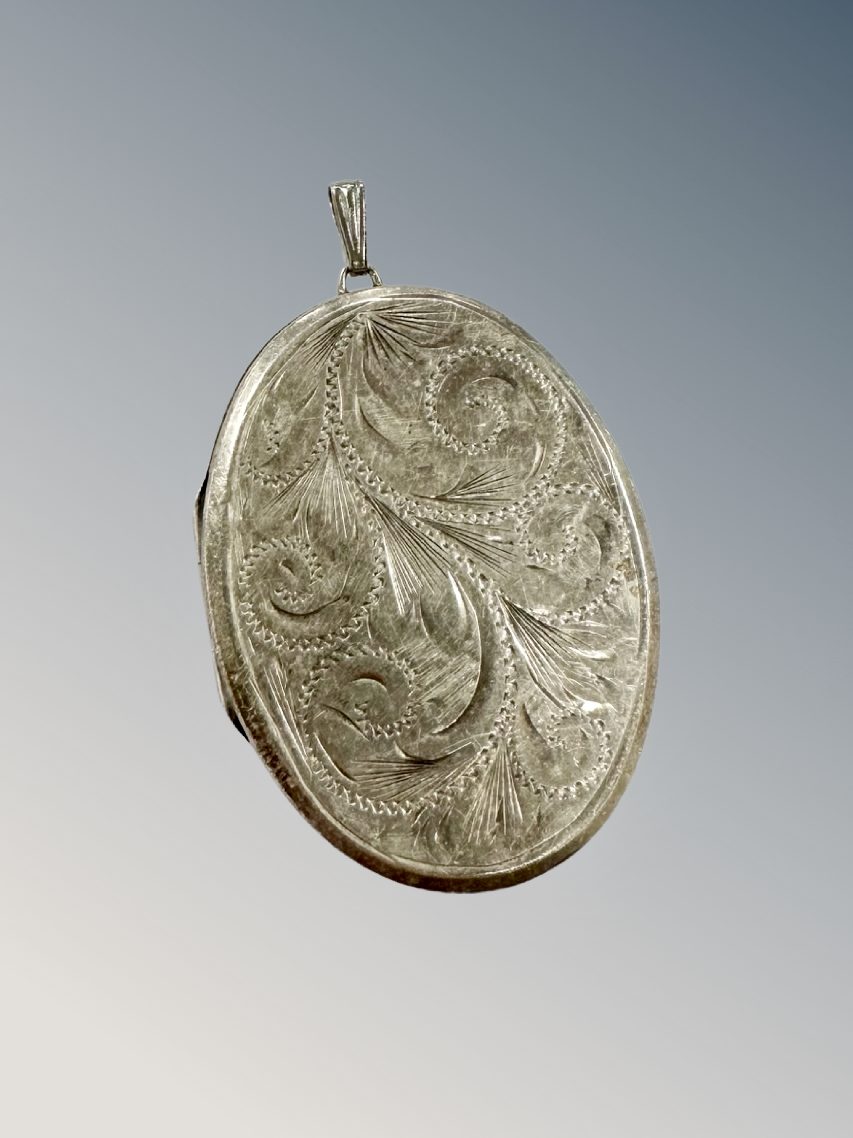 An engraved silver locket,