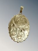 A 9ct gold engraved locket, length 4.5cm including pendant. CONDITION REPORT: 7.