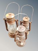 Three antique paraffin lamps.