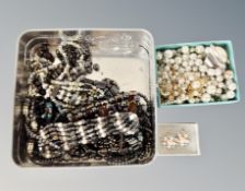 A tin of various haematic jewellery, faux and other pearls,