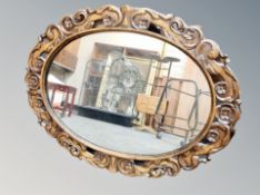 A carved beech oval mirror,