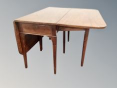 A mahogany drop leaf dining table