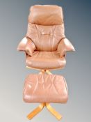 A Scandinavian brown leather armchair with matching footstool