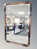 A copper framed beveled mirror, 73 cm x 49 cm.