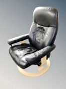 A Norwegian black leather upholstered swivel armchair