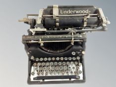 An Underwood typewriter and a child's Vulcan sewing machine.