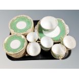 Approximately thirty six pieces of Staffordshire green and gilt tea and dinner china