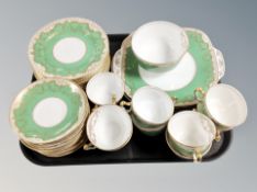 Approximately thirty six pieces of Staffordshire green and gilt tea and dinner china