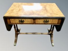 A Regency style flasp sided sofa coffee table on brass capped feet