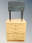 A Scandinavian oak effect chest of five drawers together with three drawer low chest