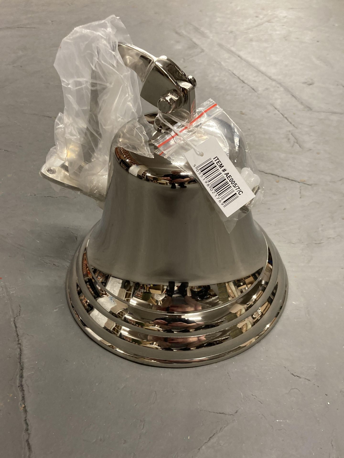 A polished steel wall bell.