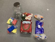 A glass lidded dispenser together with a Santa Claus ornament and a quantity of juggling items.