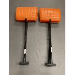 Two orange head plastic grabbing shovels.