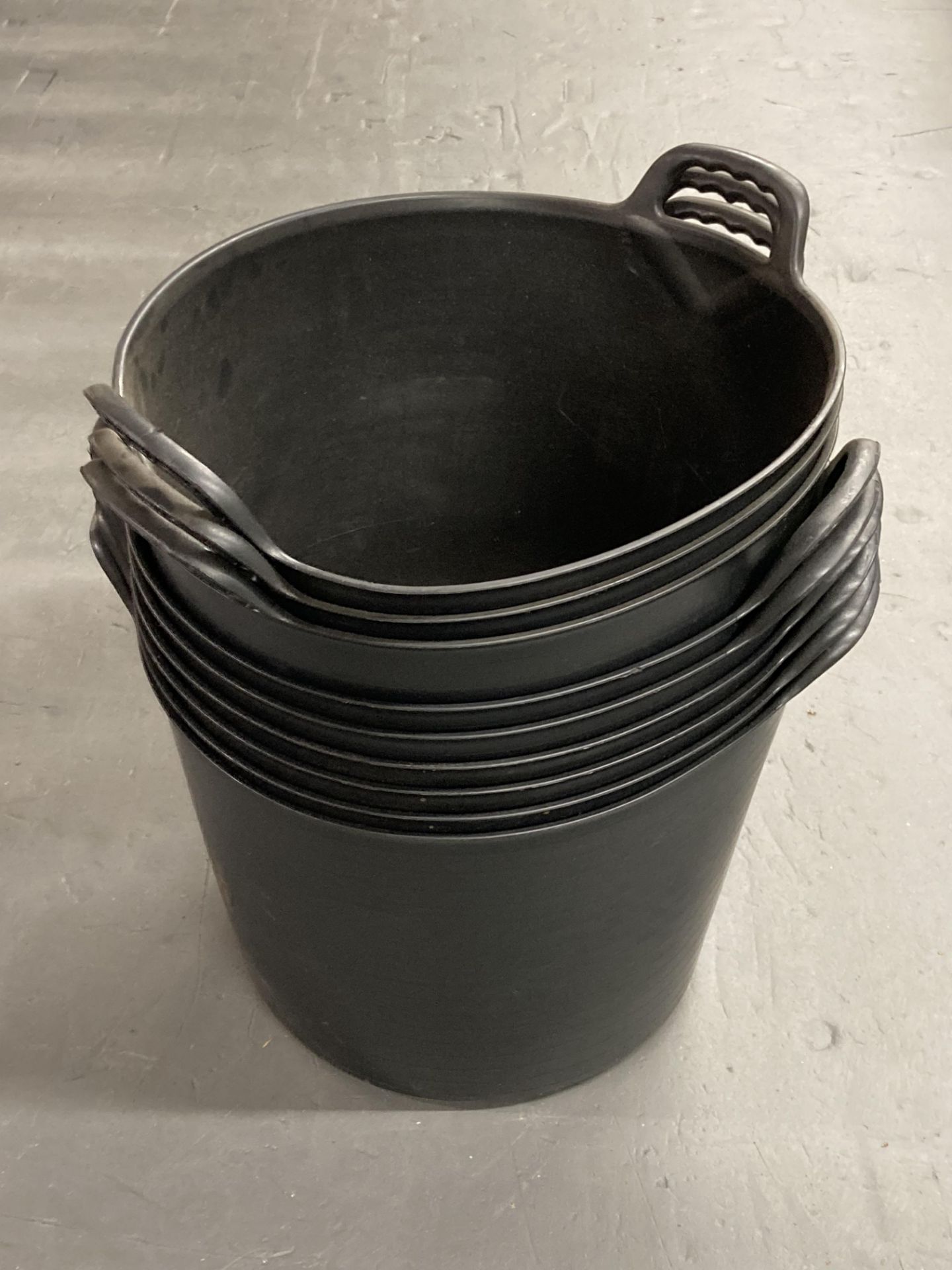 Nine black plastic flexi buckets