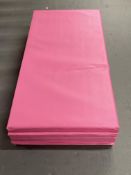 A bright pink four-fold gym mat