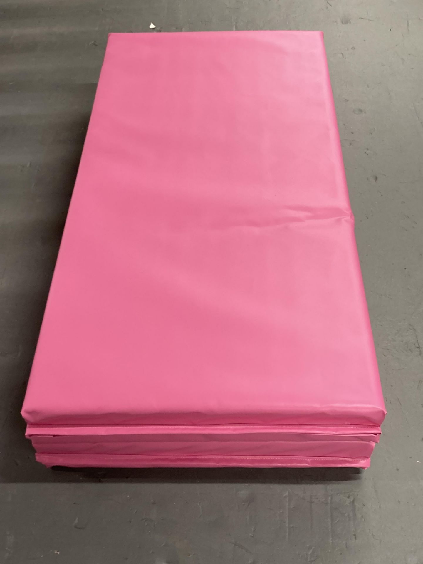 A bright pink four-fold gym mat