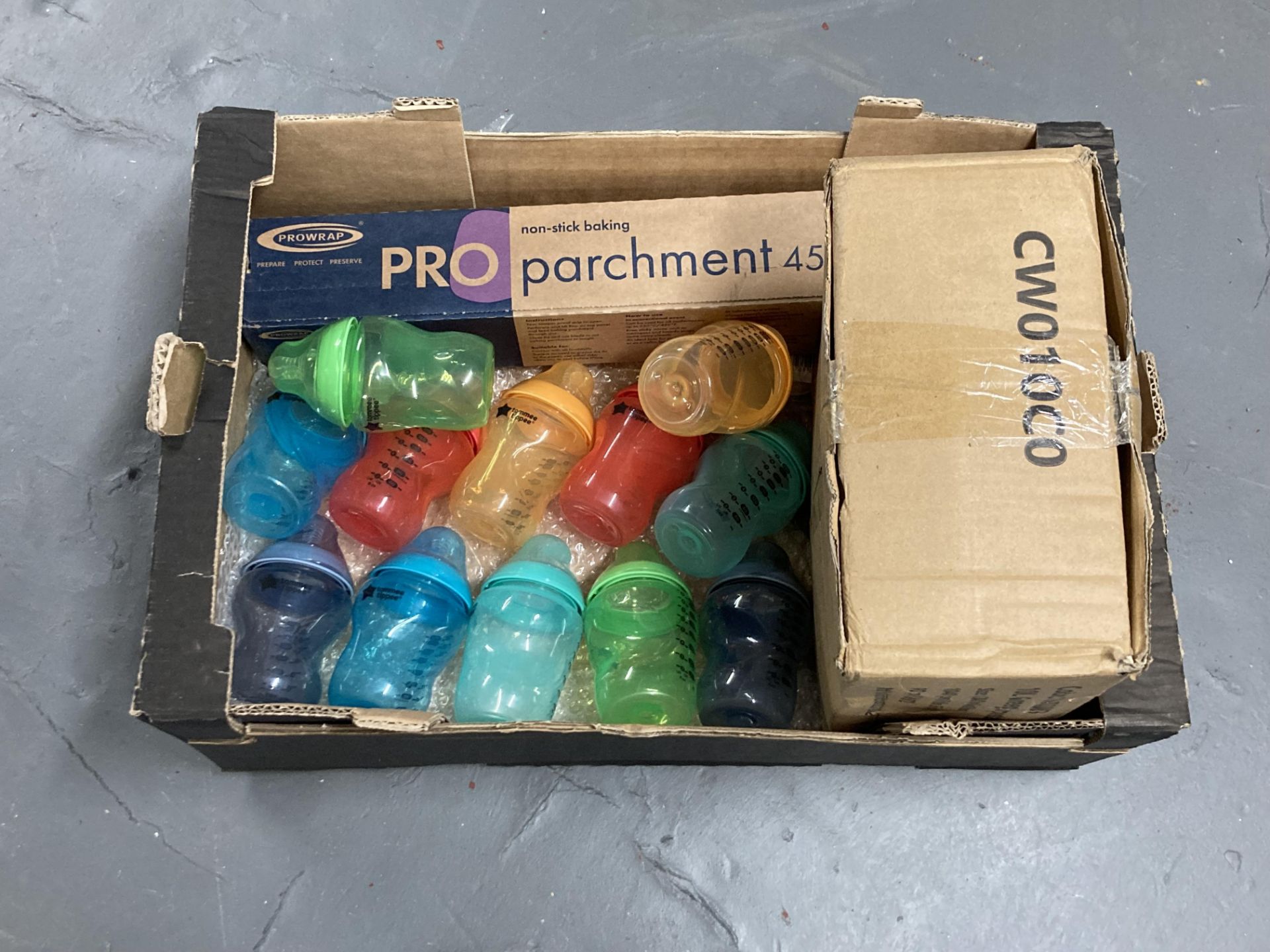 A box of non stick baking parchment, Tommy Tippee baby bottles,