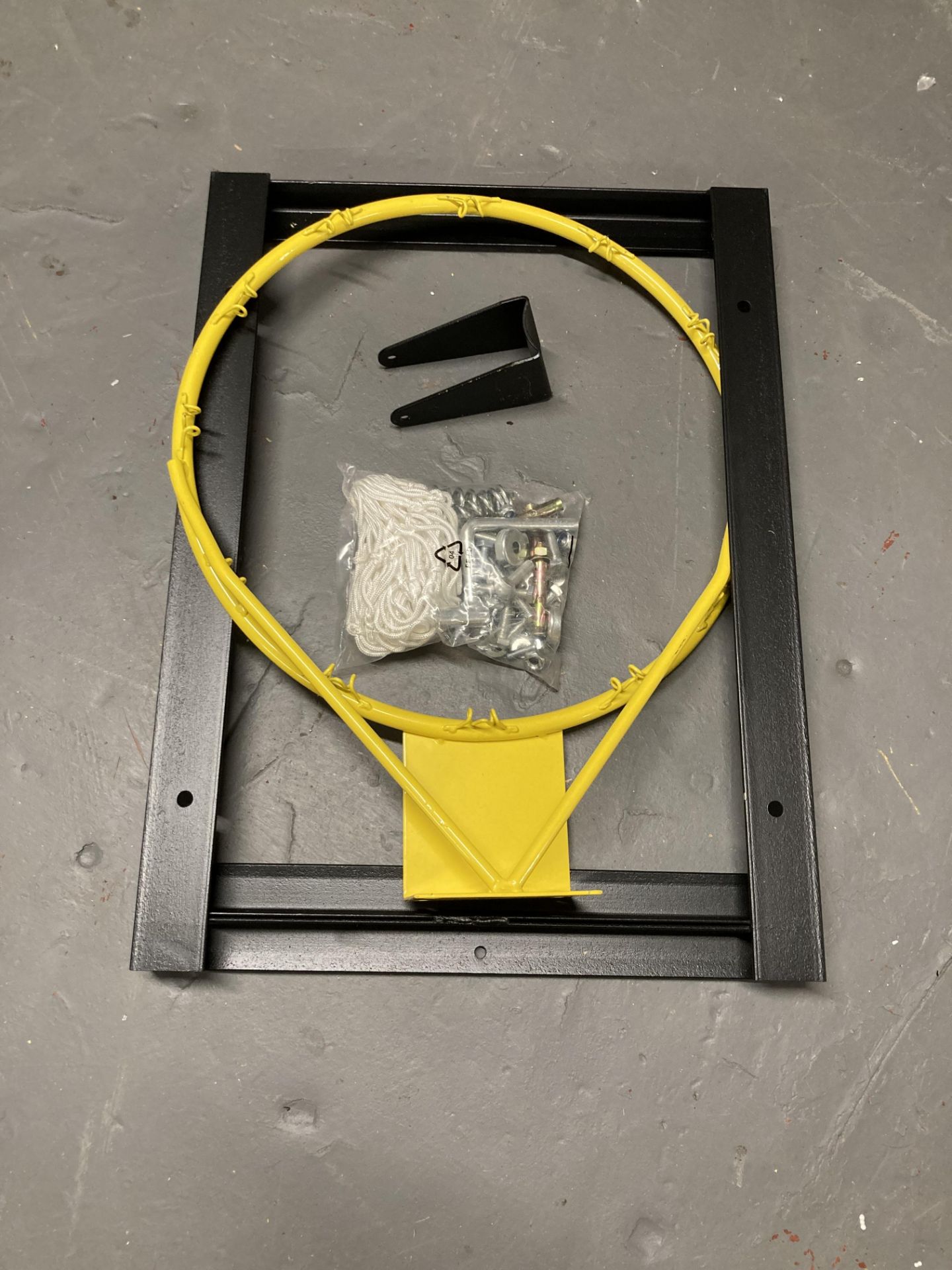 An un-used basket ball hoop with bracket and net