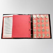 A Schulz coin album (red) containing eighty collectable 50 pence coins, various dates and themes.