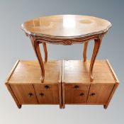 A pair of teak effect low chests together with an oval occasional table