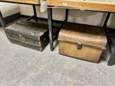 A tin trunk together with a further wooden bound trunk