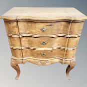 A 19th century oak serpentine three drawer chest,