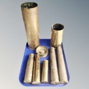 A tray of seven 20th century brass ammunition shell cases together with a further shell case