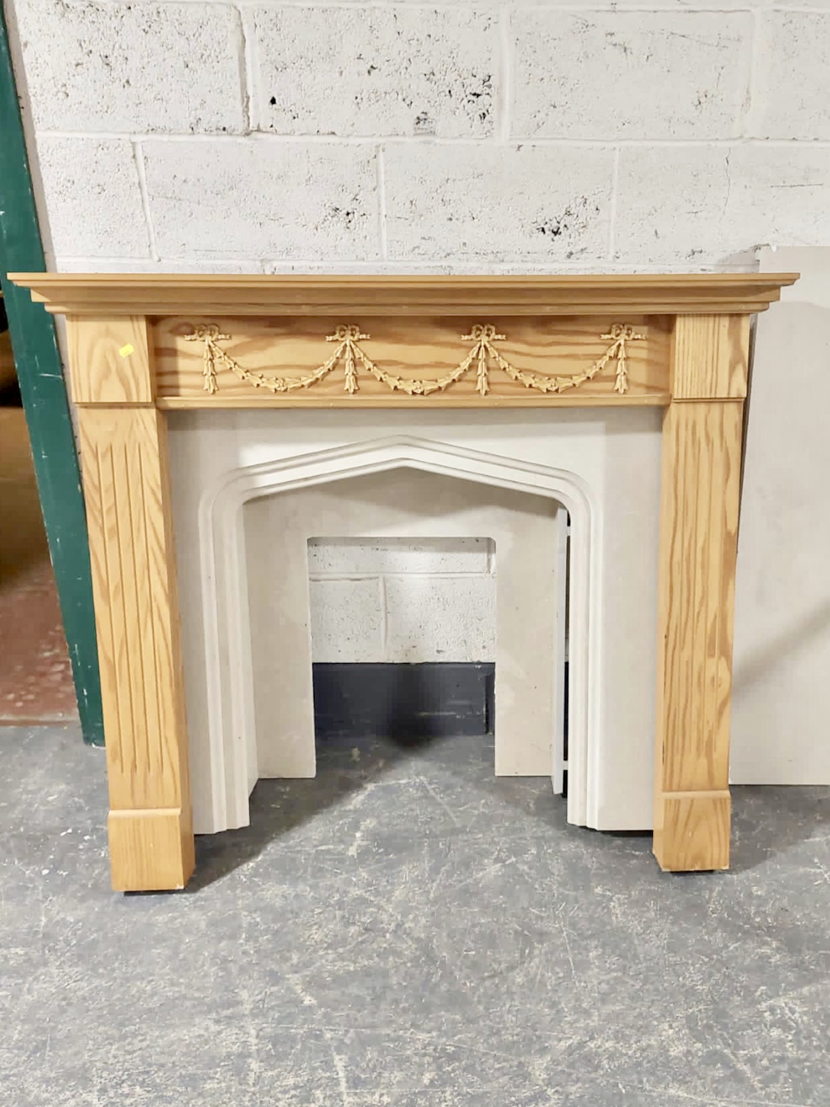 A three piece marble fire surround and a further pine surround