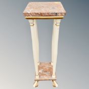 A rouge marble torchere with cream and gilt supports,