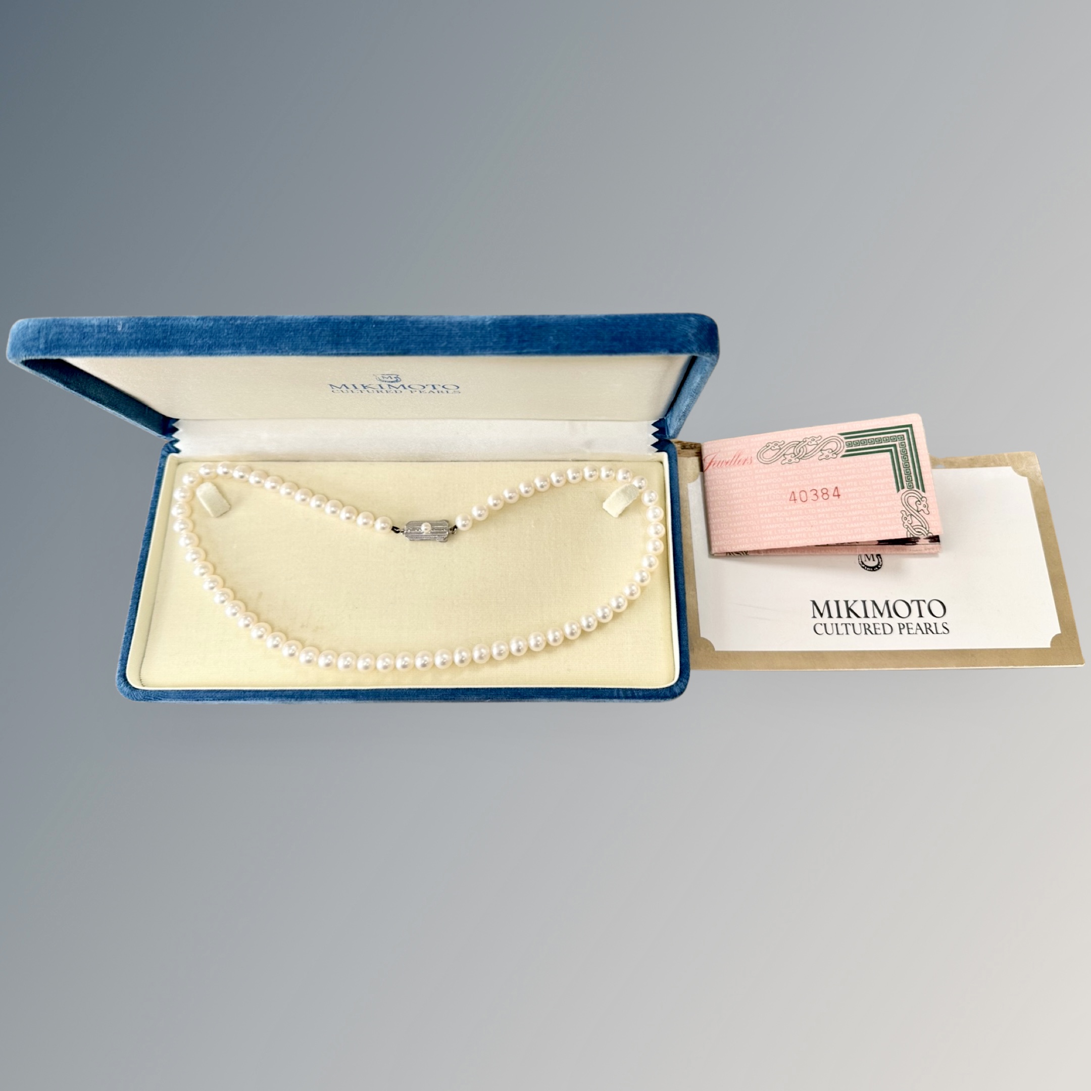 A Mikimoto cultured pearl single-strand necklace with silver clasp,