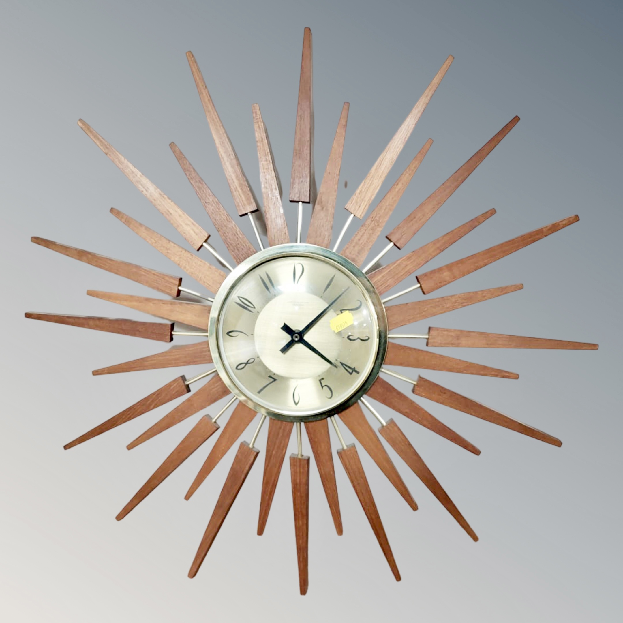 An Anstey & Wilson teak sunburst wall clock