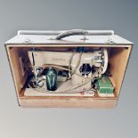 A Singer 201k electric sewing machine in case,