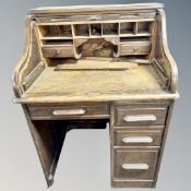 A 1930's oak single pedestal roll top desk,