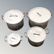 Four graduated twin-handled aluminium cooking pots