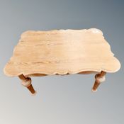 An early 20th century shaped pine low table