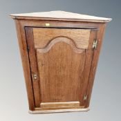 A George III oak corner cabinet