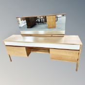 An oak effect dressing table with mirror back,