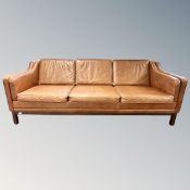 A late 20th century Scandinavian tan leather three seater settee,