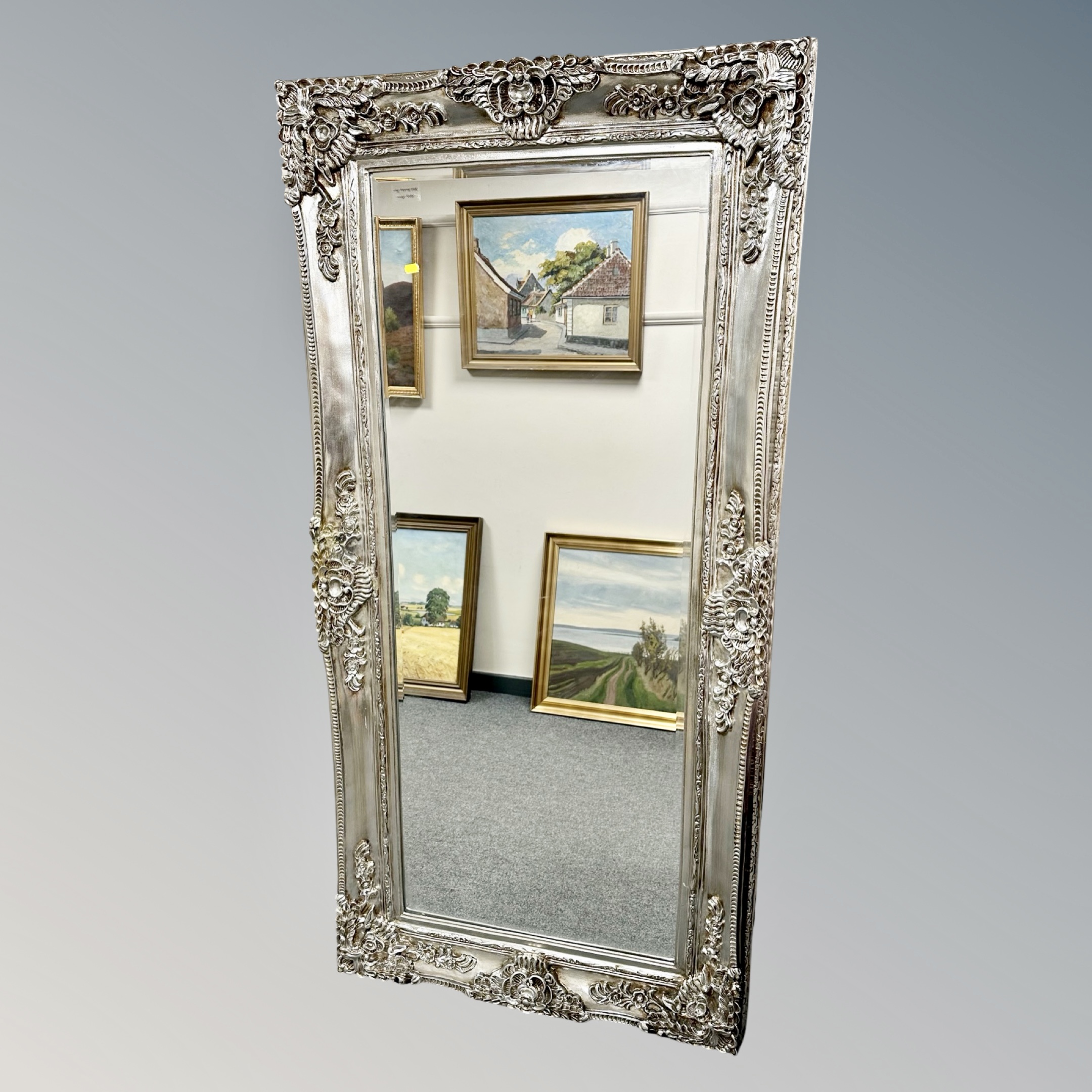 An ornate silvered mirror,