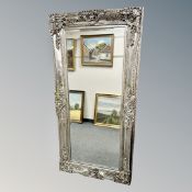 An ornate silvered mirror,