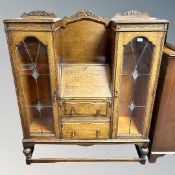 A 1930's glazed oak bureau bookcase,