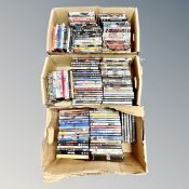 Three boxes containing approximately 150 DVD's